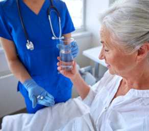 a nurse giving medicine to a patient