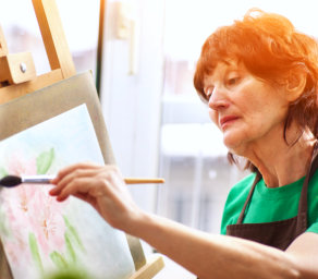 an elderly woman painting