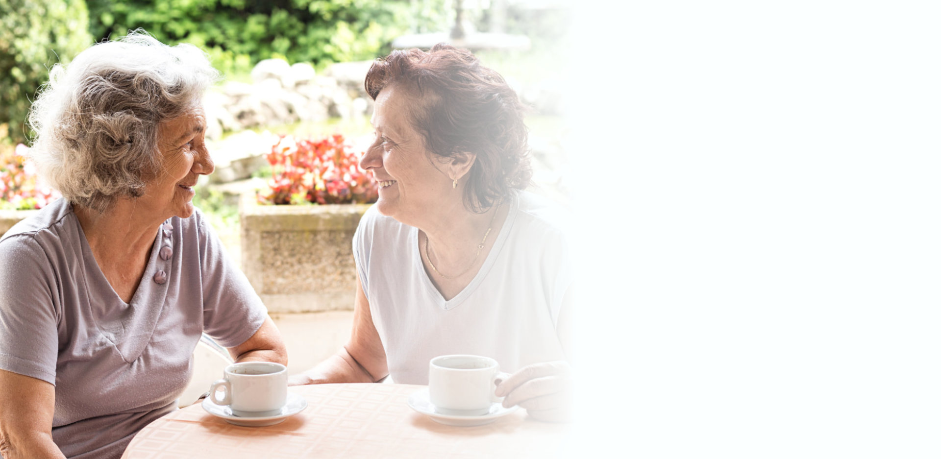 Senior woman drinking coffee and talking outdoors