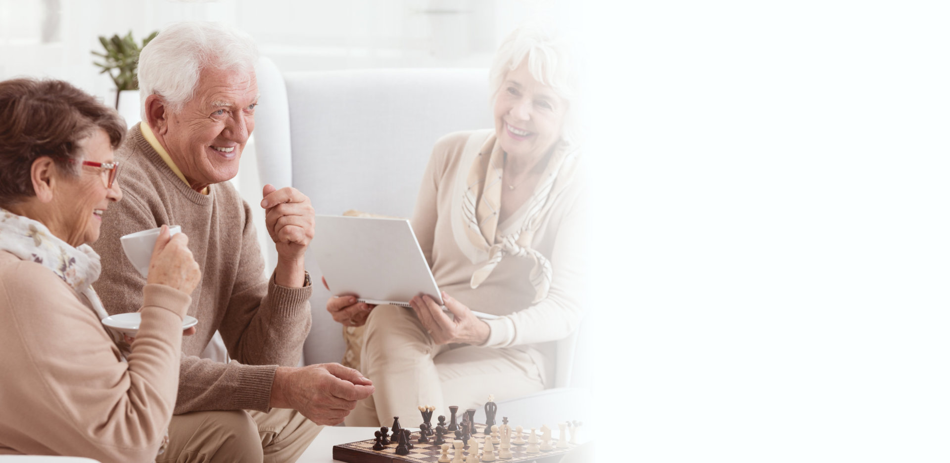 Happy pensioners of rest home playing chess