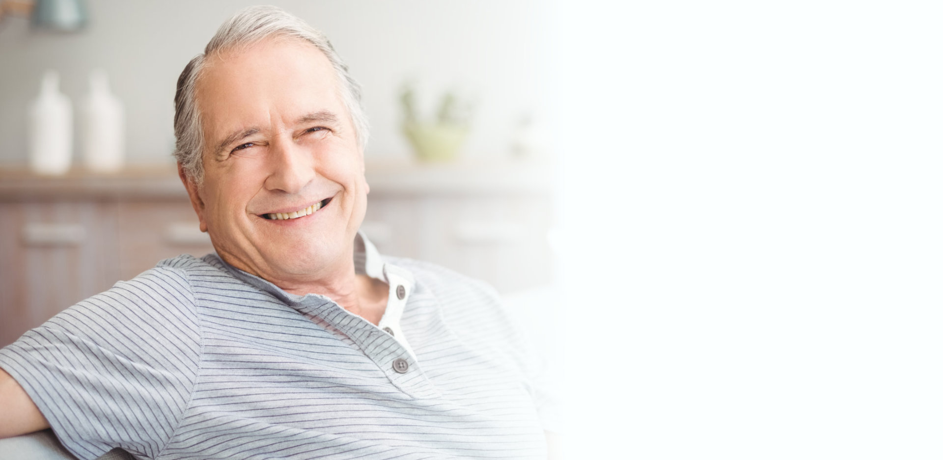 Portrait of happy senior man smiling at home