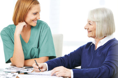 woman and elderly woman having an activity using pencil and paper