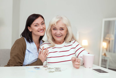 woman hugging elderly woman beside her