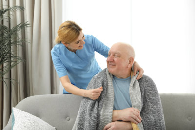 woman giving towel to an elderly man