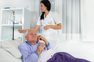 woman checking dextrose of elderly man